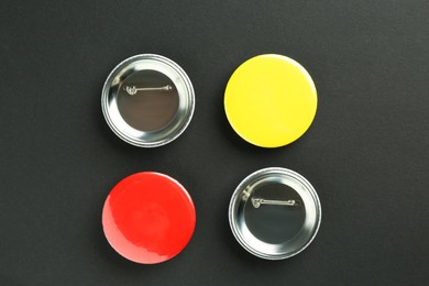 Photo of Button badges on black background, flat lay. Mockup for design