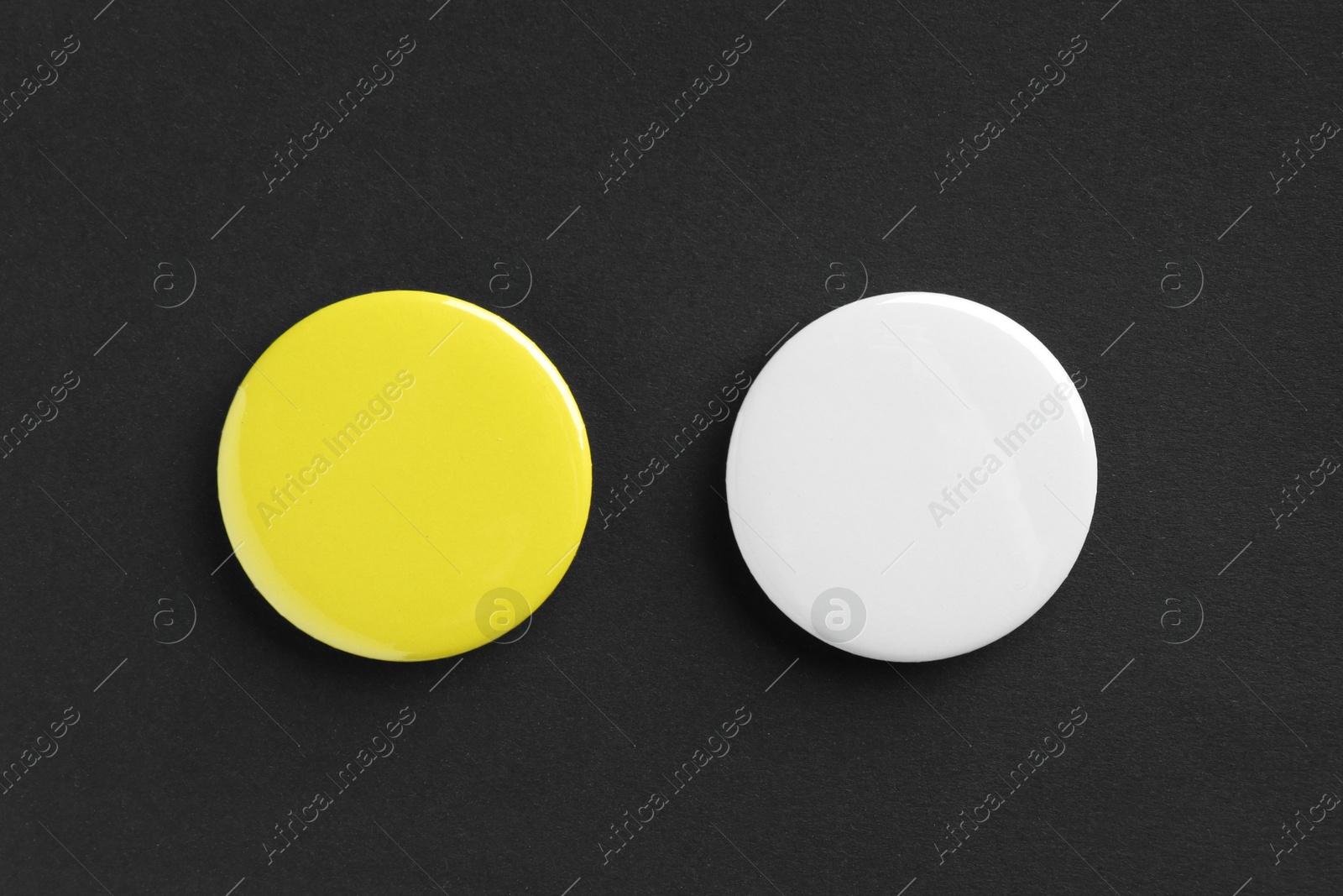 Photo of Button badges on black background, flat lay. Mockup for design