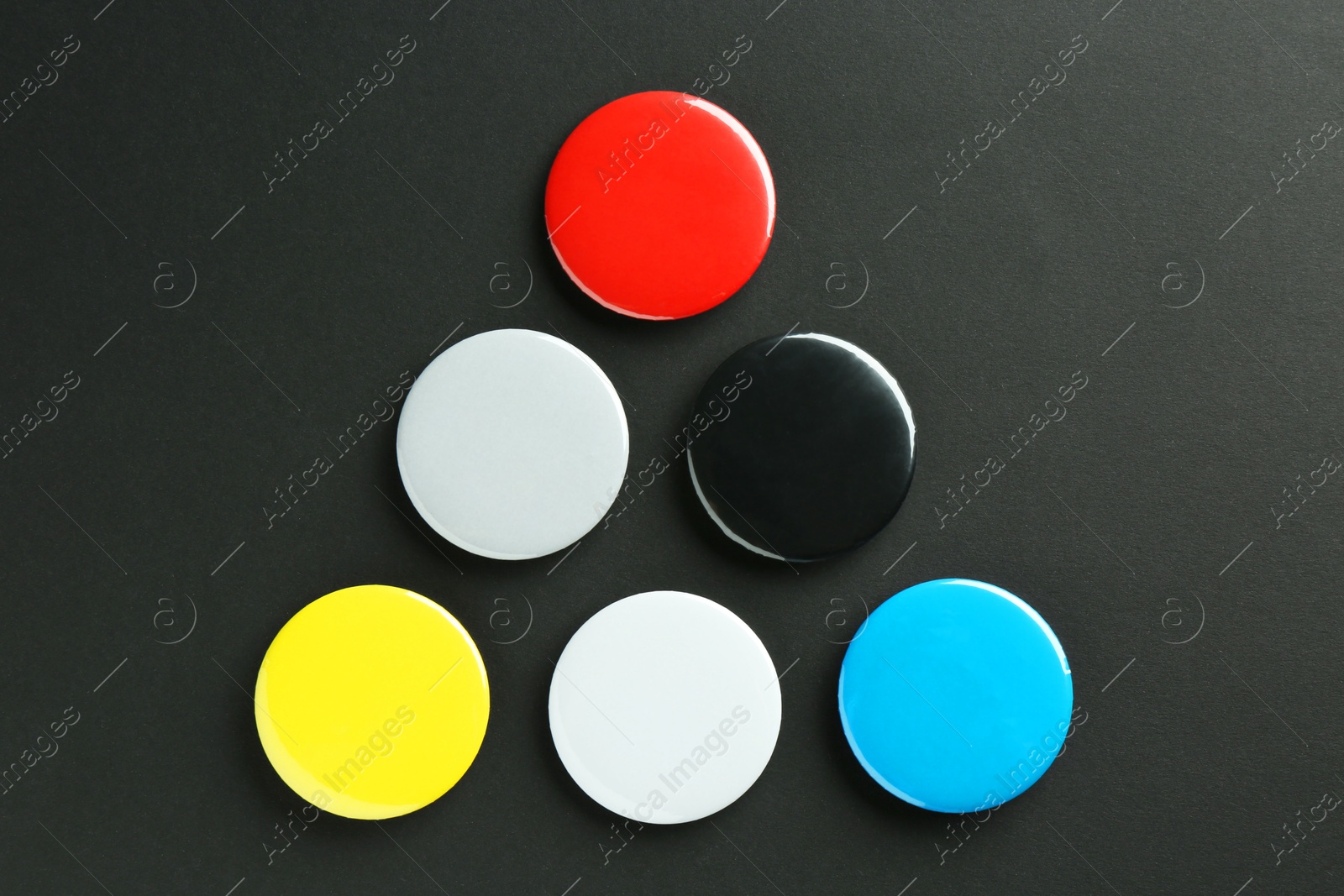 Photo of Button badges on black background, flat lay. Mockup for design