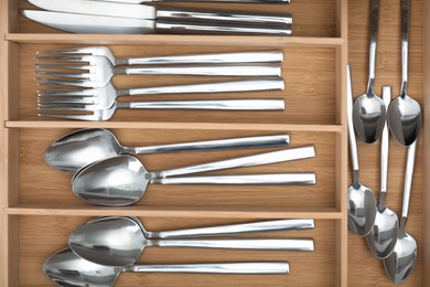 Photo of Box with cutlery in drawer, top view. Kitchen utensils storage