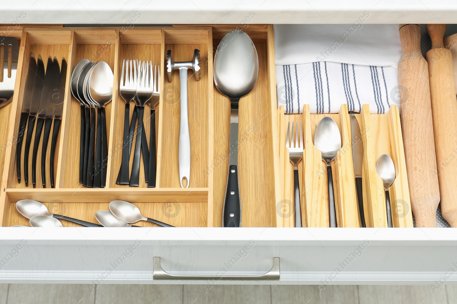 Photo of Box with cutlery in drawer, closeup. Kitchen utensils storage