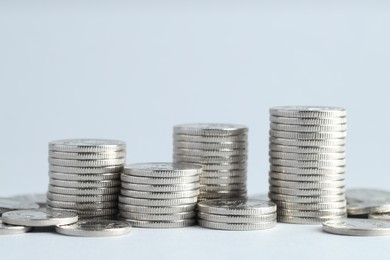 Photo of Salary concept. Stacked coins on light grey background, closeup. Space for text