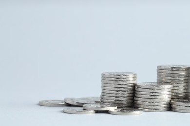 Photo of Salary concept. Stacked coins on light grey background, closeup. Space for text