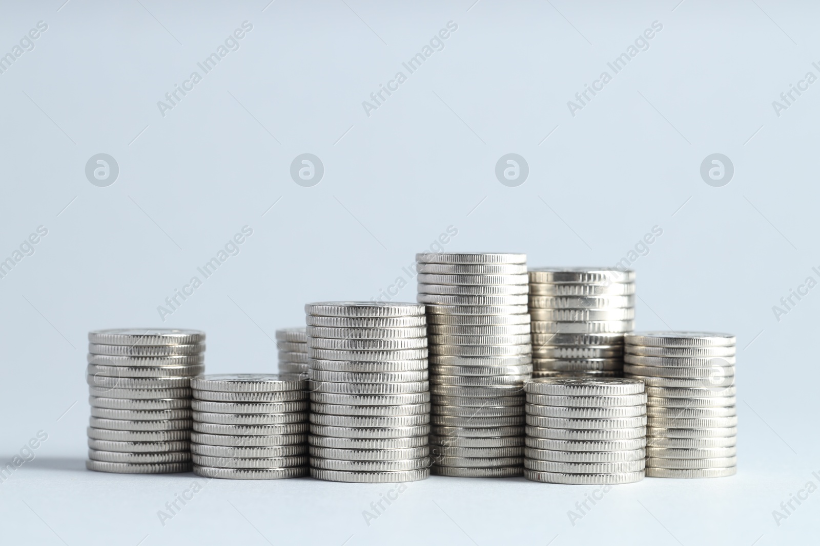 Photo of Salary concept. Stacked coins on light grey background