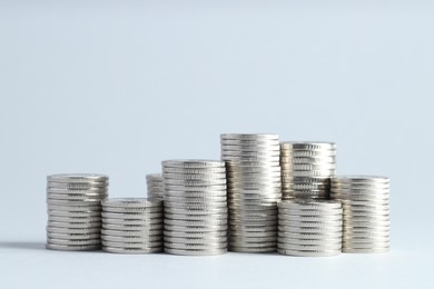 Photo of Salary concept. Stacked coins on light grey background