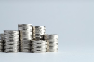 Photo of Salary concept. Stacked coins on light grey background