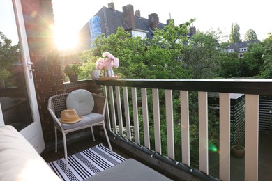 Photo of Different plants on railings and chair at cozy balcony outdoors