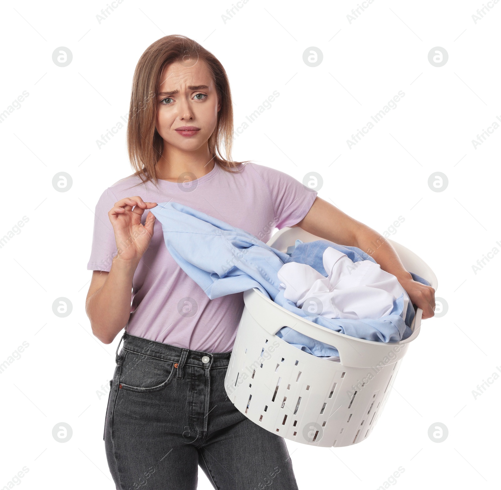 Photo of Tired housewife with basket full of laundry on white background