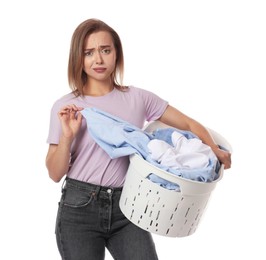 Tired housewife with basket full of laundry on white background