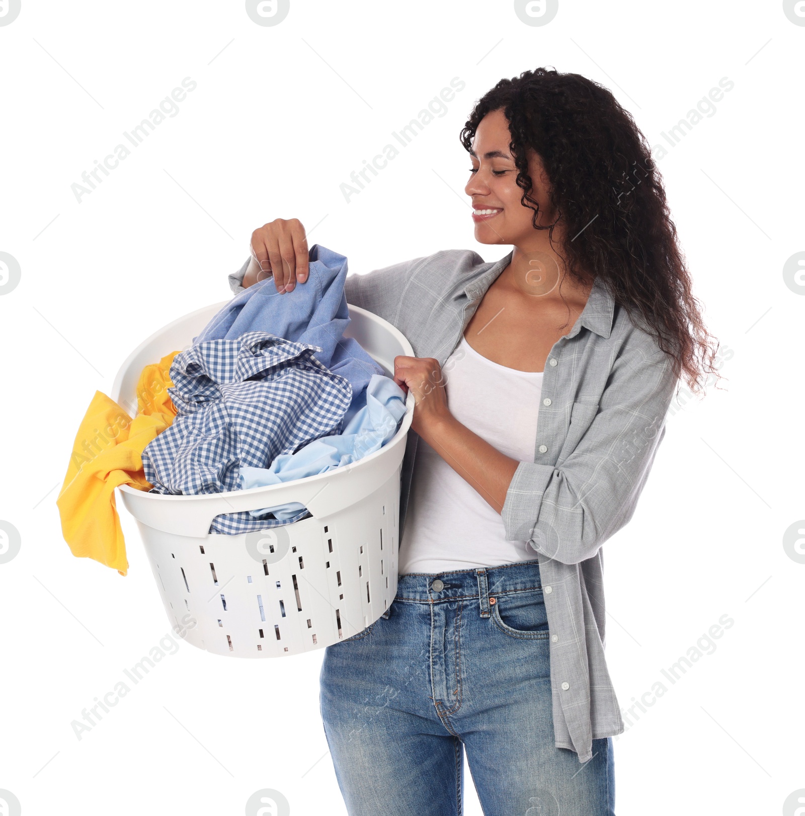 Photo of Happy woman with basket full of laundry on white background