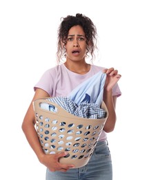 Emotional woman with basket full of laundry on white background