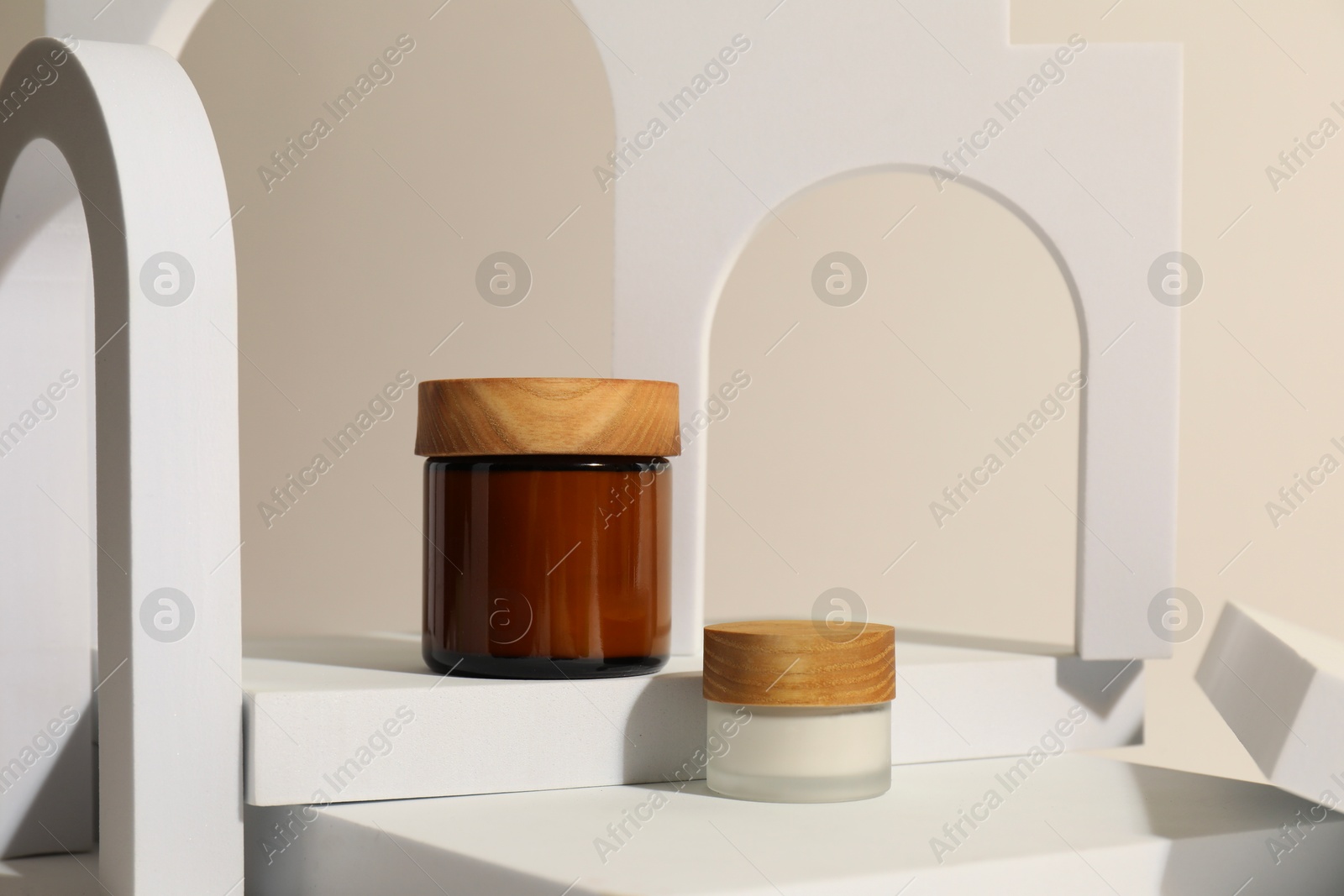 Photo of Stylish presentation of facial cream on beige background