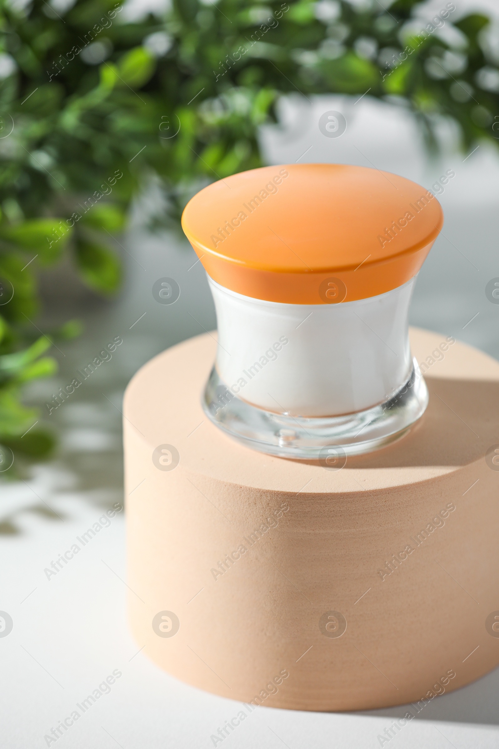 Photo of Stylish presentation of facial cream on white table, closeup