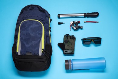 Photo of Flat lay composition with cycling accessories on light blue background