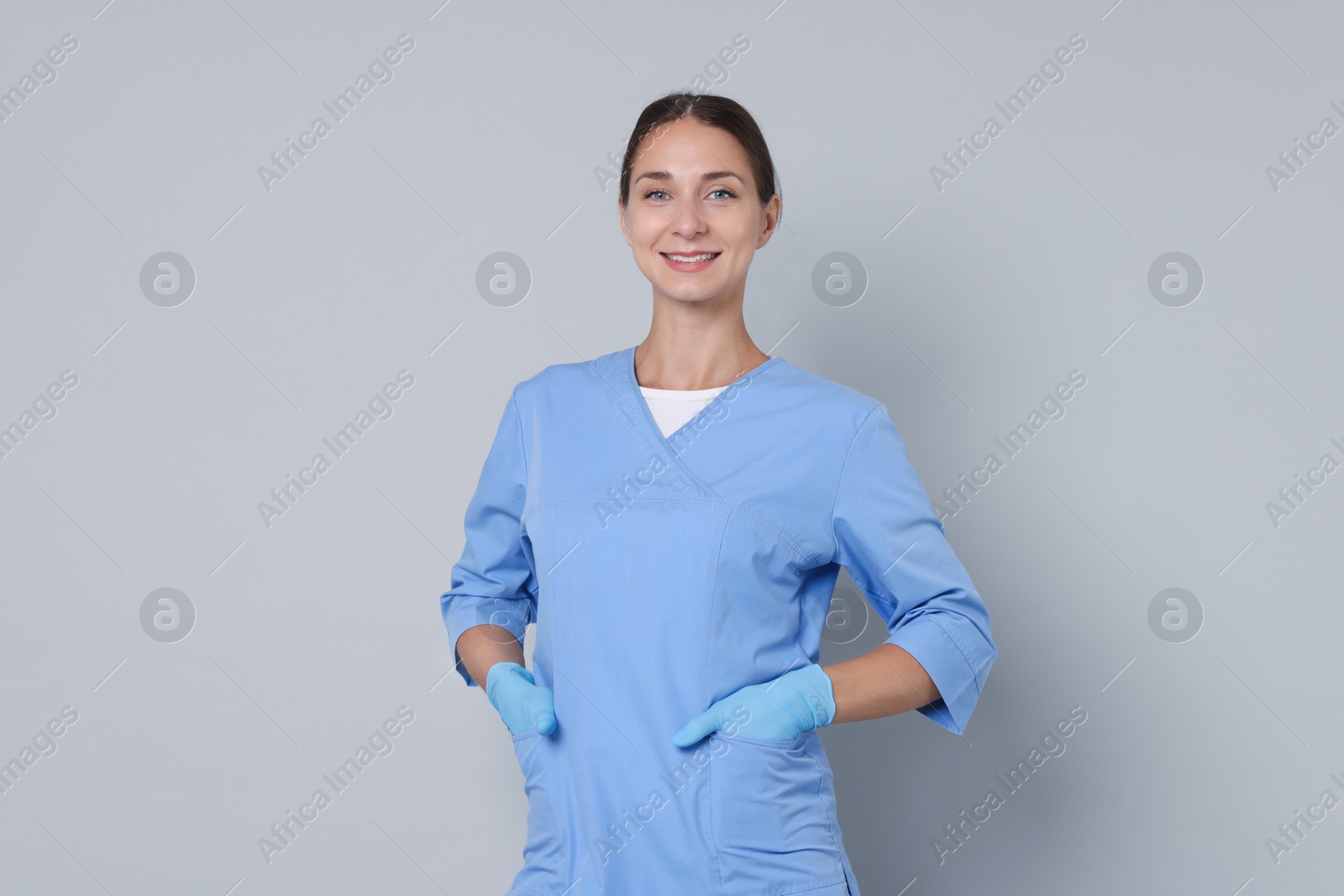 Photo of Nurse in medical uniform on grey background