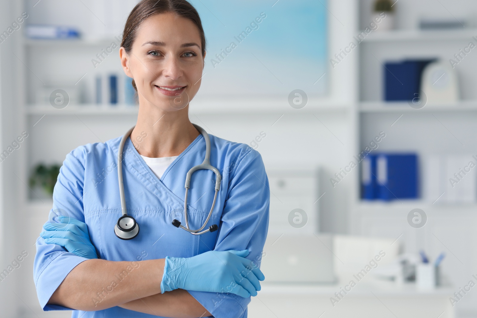 Photo of Nurse in medical uniform with stethoscope indoors, space for text