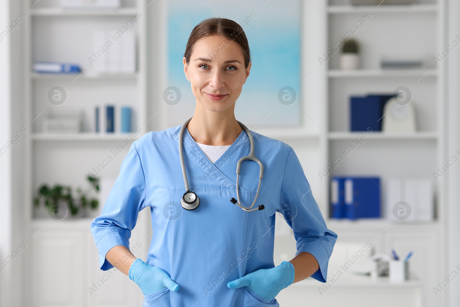 Photo of Nurse in medical uniform with stethoscope indoors