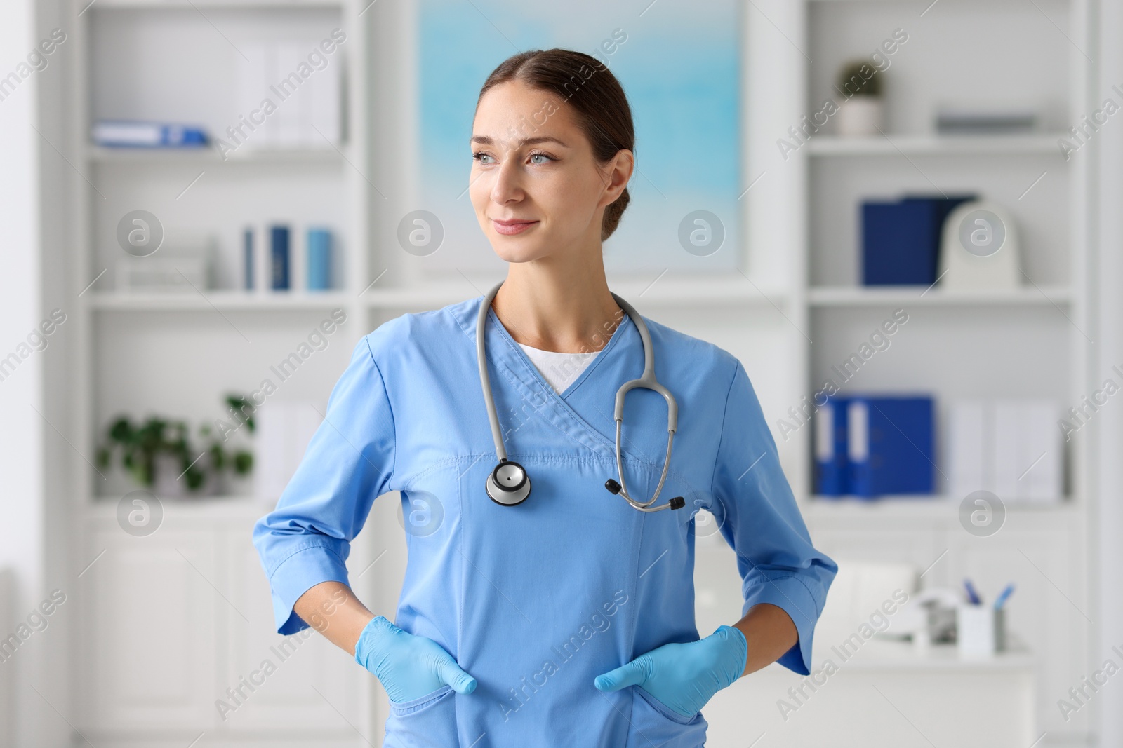 Photo of Nurse in medical uniform with stethoscope indoors