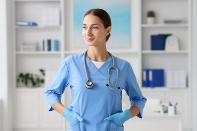 Photo of Nurse in medical uniform with stethoscope indoors