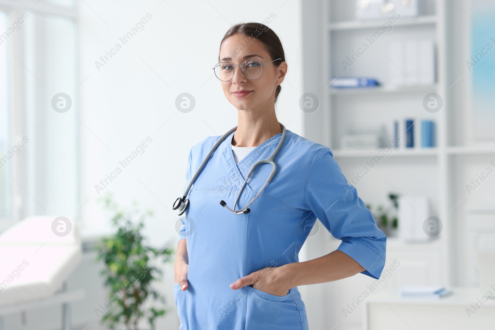 Photo of Nurse in medical uniform with stethoscope indoors