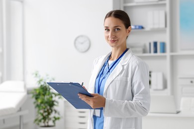 Nurse in medical uniform with clipboard indoors