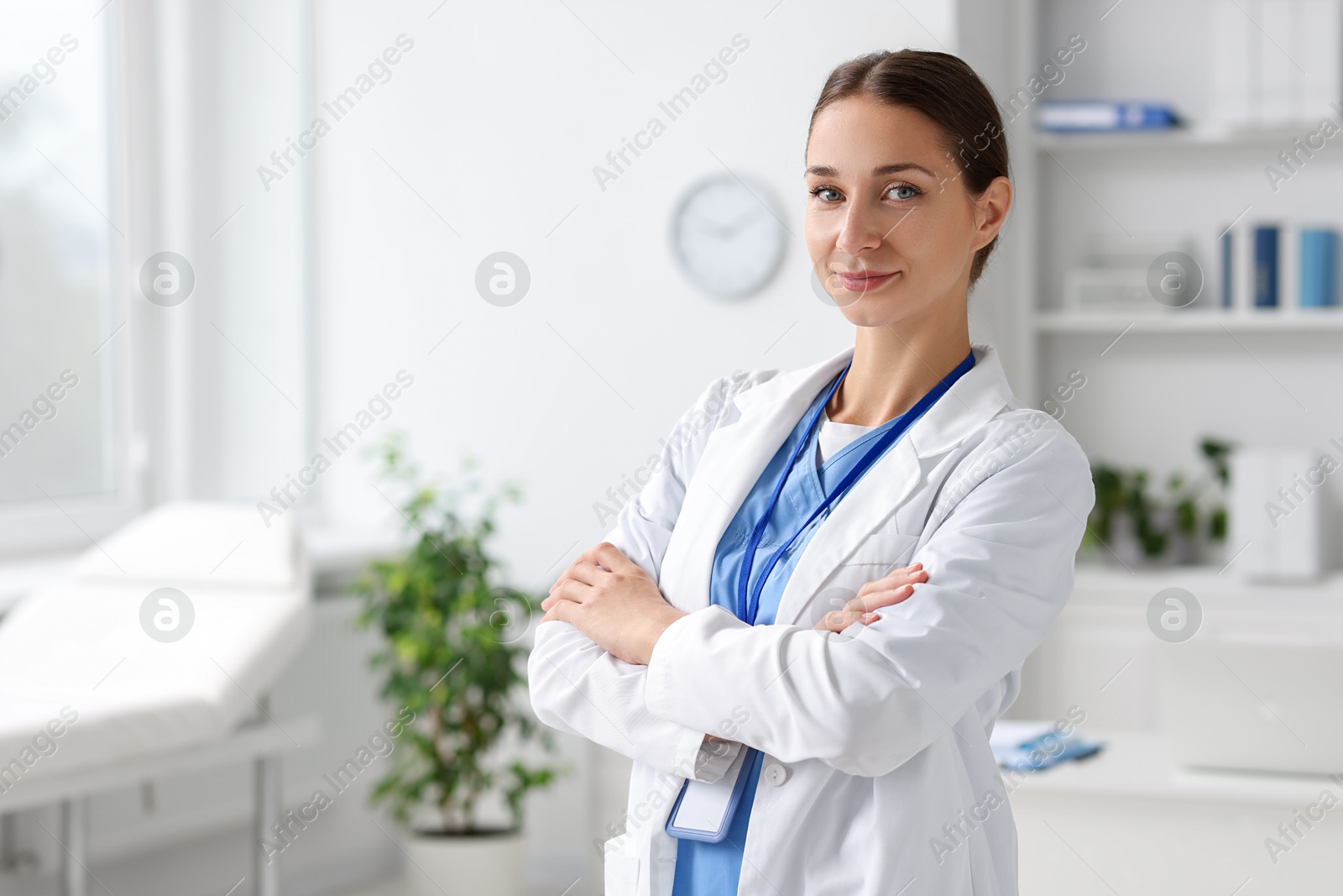 Photo of Nurse with crossed arms in clinic, space for text