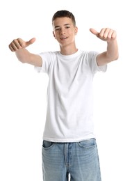 Photo of Teenage boy wearing t-shirt and showing thumbs up on white background