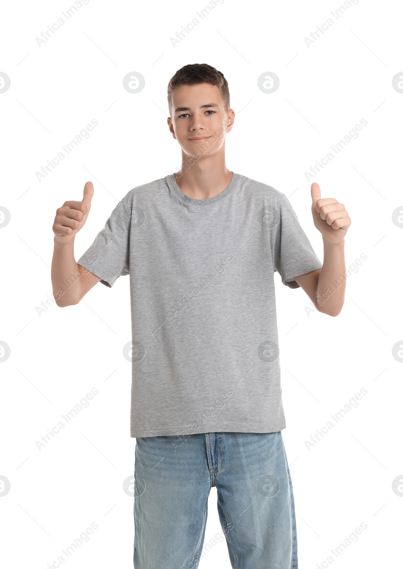 Photo of Teenage boy wearing grey t-shirt and showing thumbs up on white background