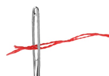 Photo of Sewing needle with red thread isolated on white, closeup