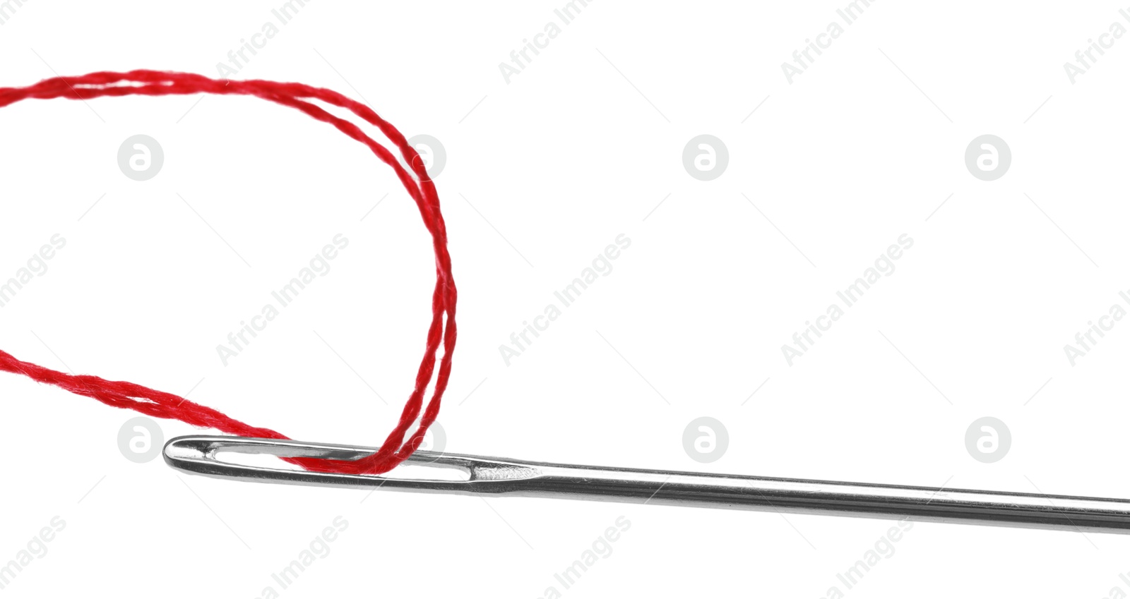 Photo of Sewing needle with red thread isolated on white, closeup