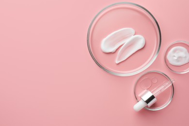 Petri dishes with cosmetic products and pipette on pink background, flat lay. Space for text