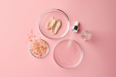 Petri dishes with cosmetic products, sea salt and pipette on pink background, flat lay