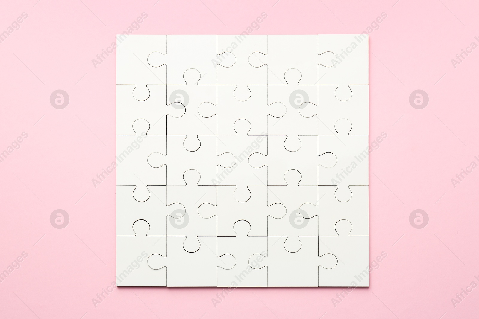 Photo of White puzzle on pink background, top view