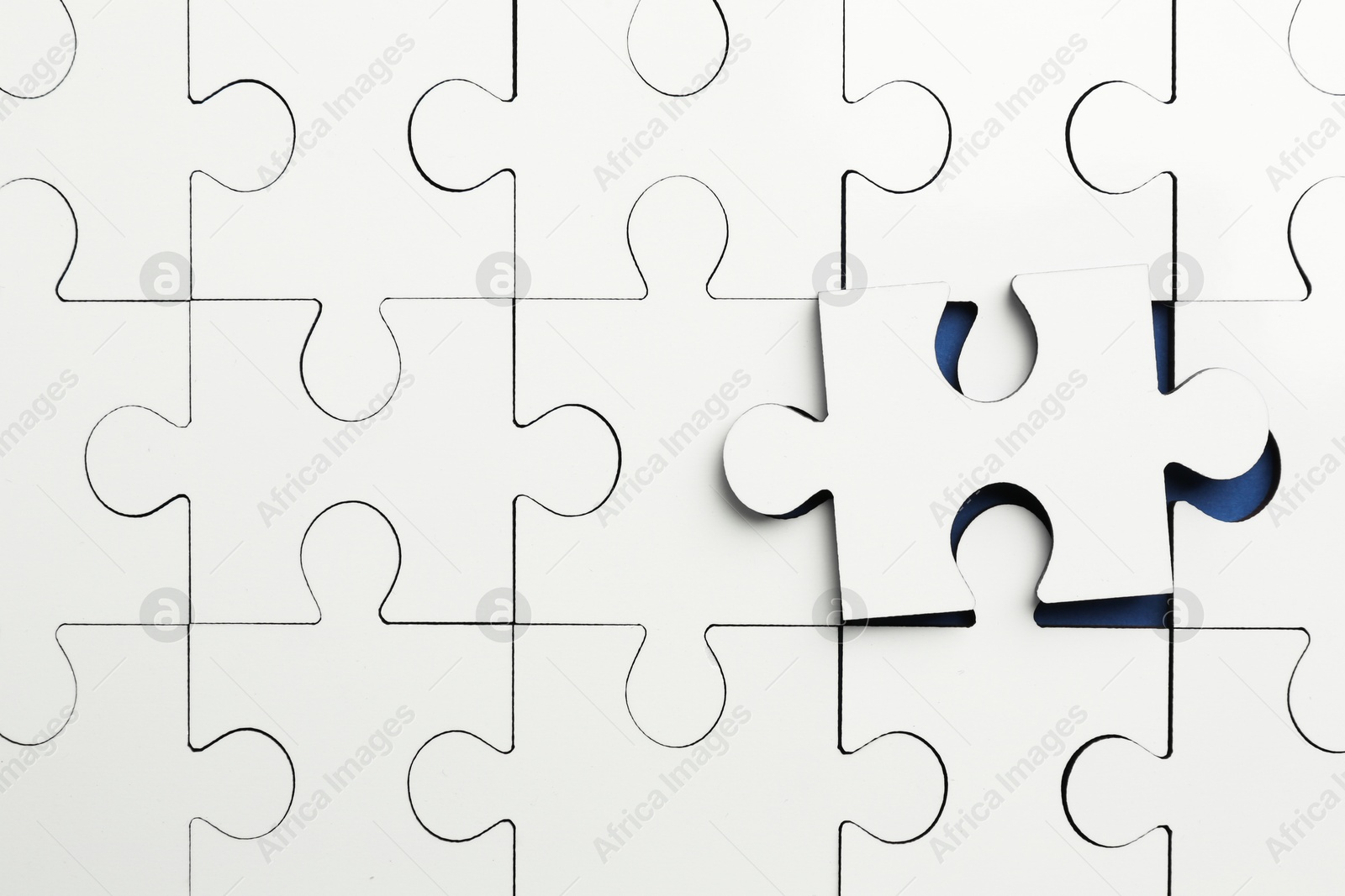 Photo of White puzzle pieces on blue background, top view