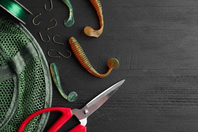 Photo of Fishing baits, hooks, net, line and scissors on grey wooden table, flat lay. Space for text