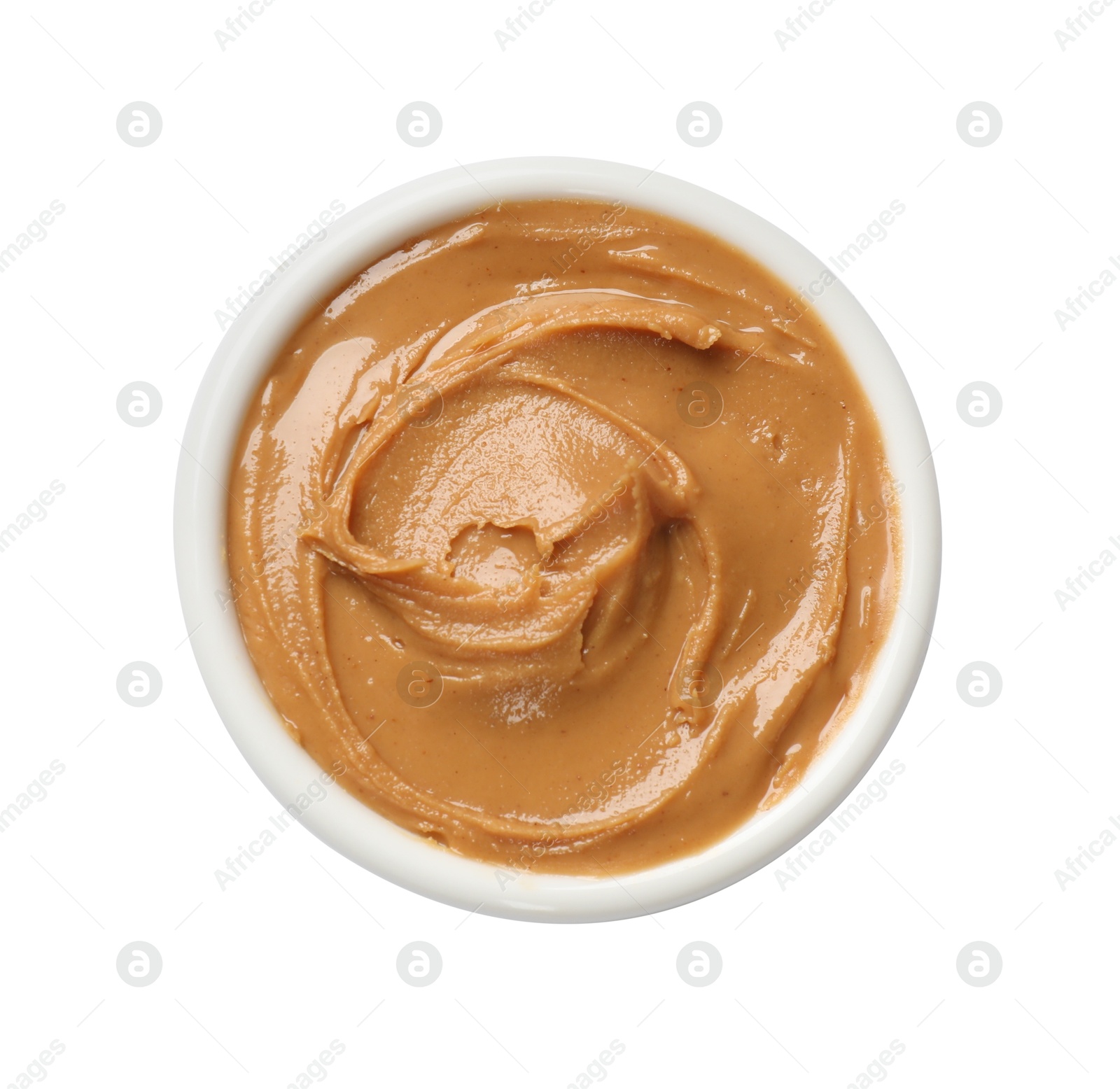 Photo of Tasty peanut butter in bowl isolated on white, top view