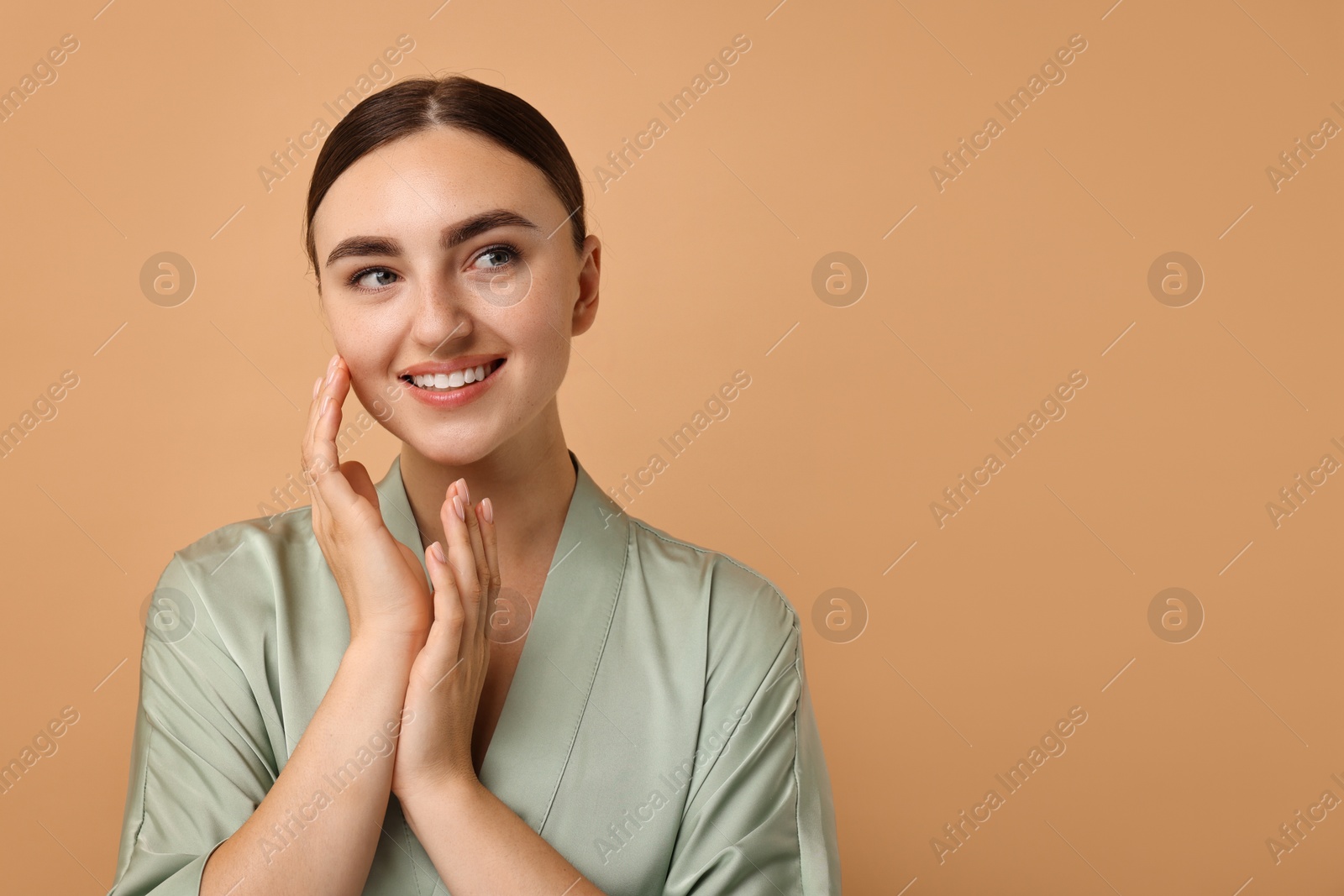 Photo of Beautiful young woman with healthy skin on beige background, space for text