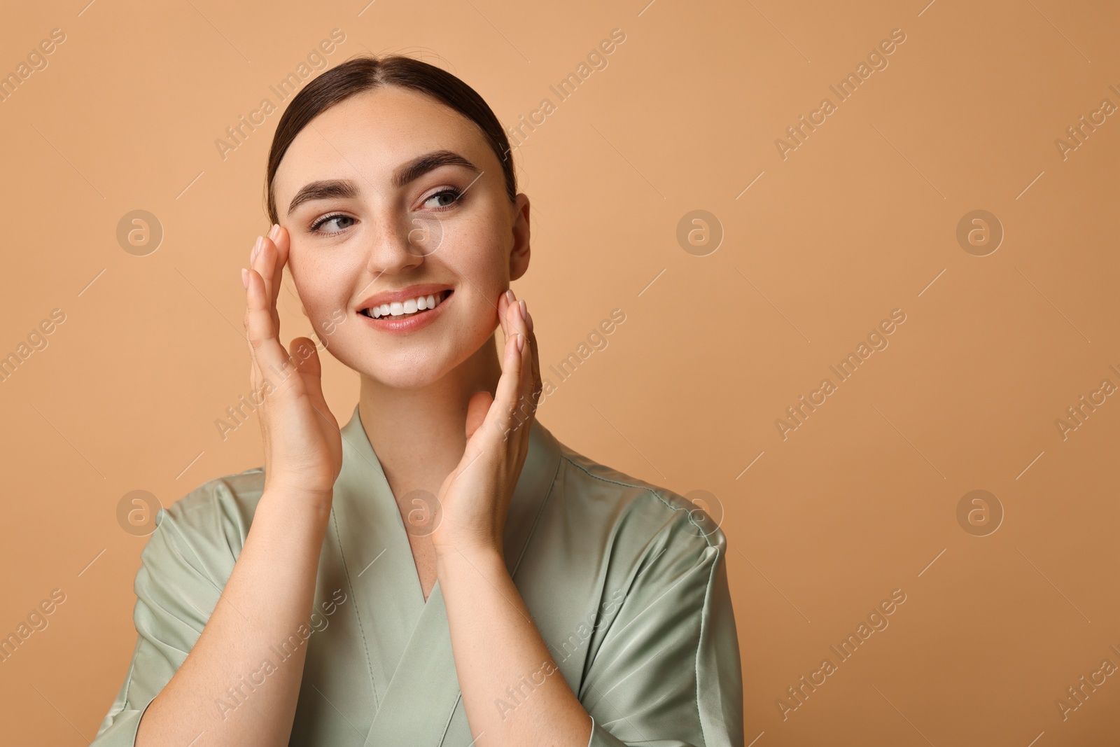 Photo of Beautiful young woman with healthy skin on beige background, space for text