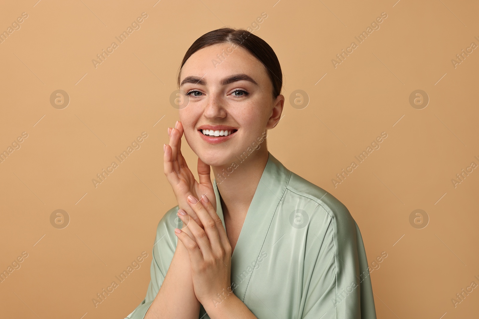 Photo of Beautiful young woman with healthy skin on beige background