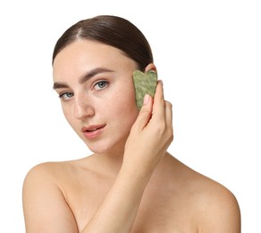 Photo of Beautiful young woman doing facial massage with gua sha tool on white background