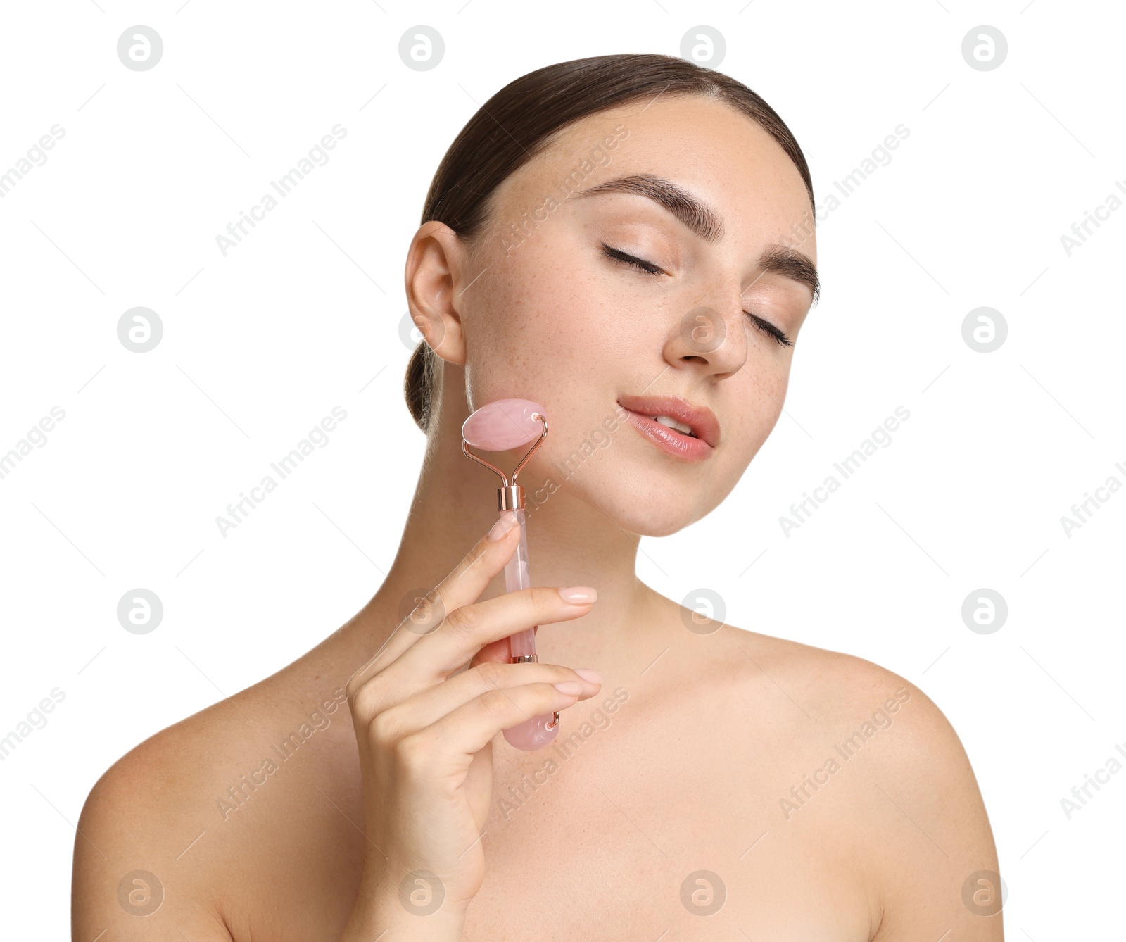 Photo of Beautiful young woman doing facial massage with roller on white background