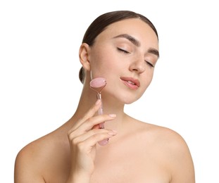 Beautiful young woman doing facial massage with roller on white background