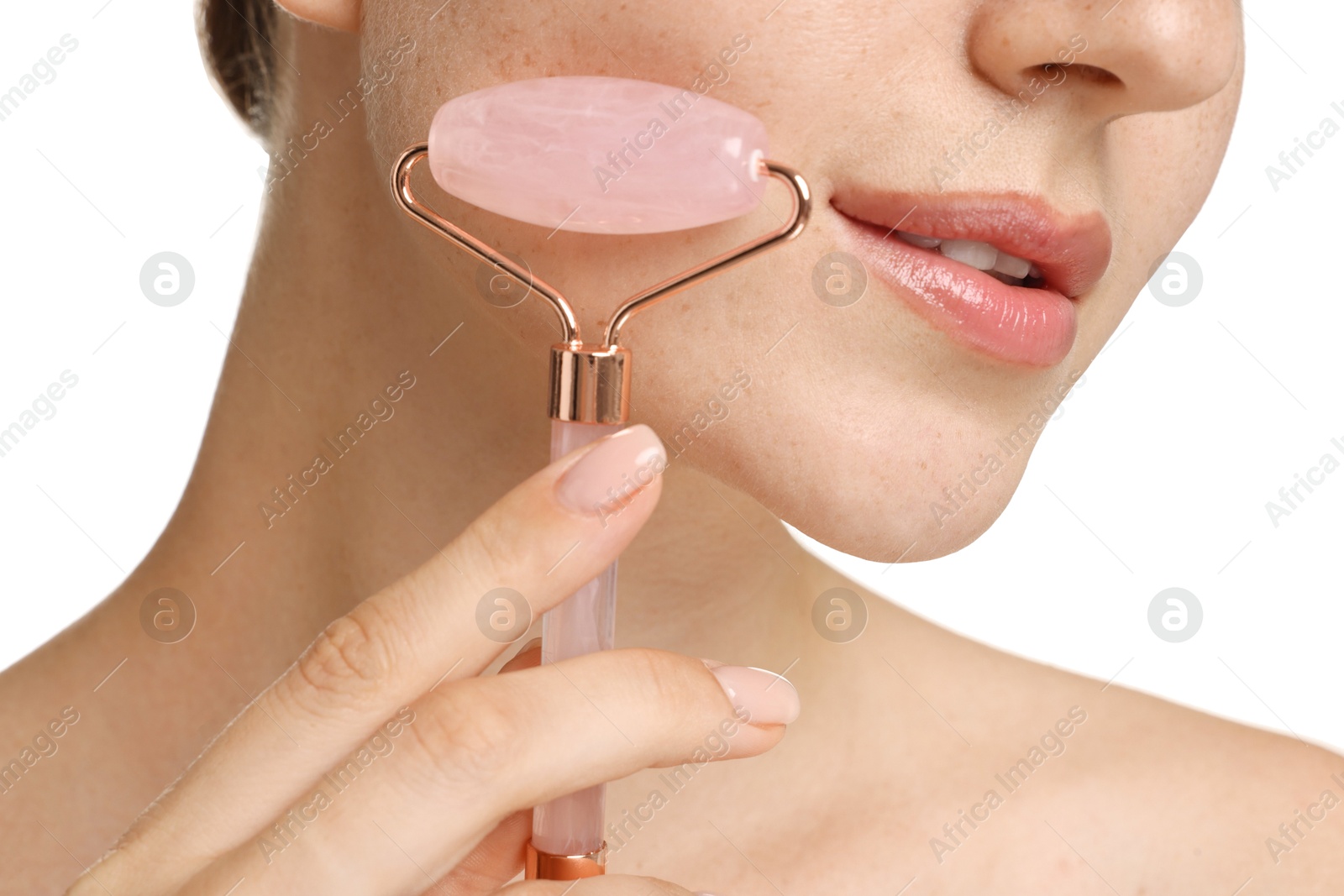 Photo of Woman doing facial massage with roller on white background, closeup