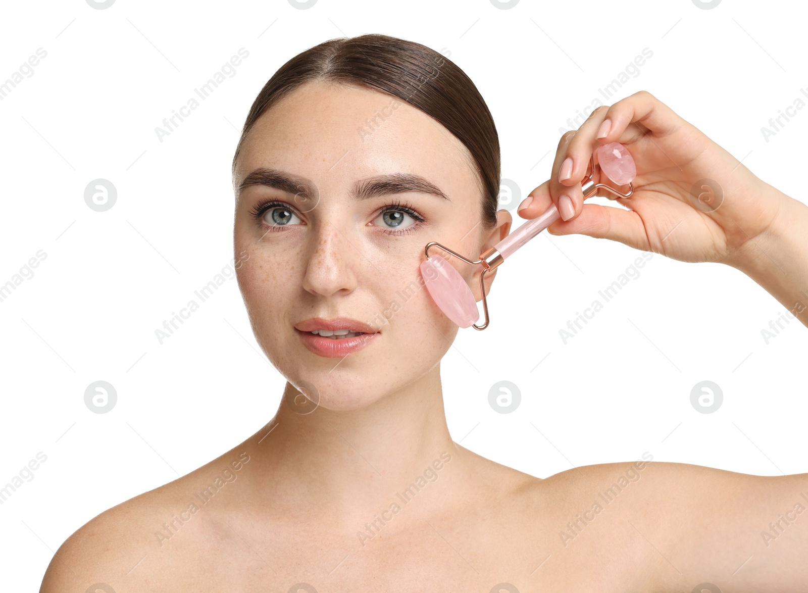 Photo of Beautiful young woman doing facial massage with roller on white background