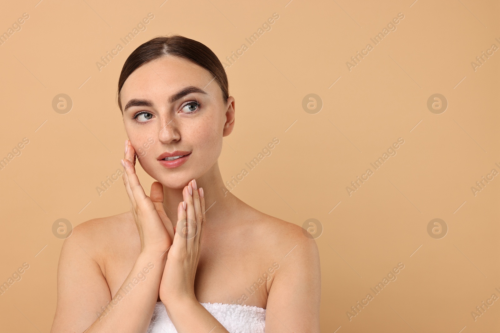 Photo of Beautiful young woman with healthy skin on beige background, space for text