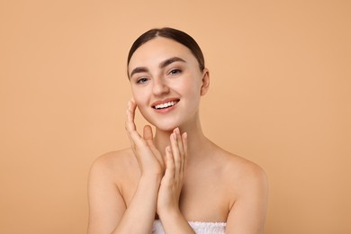 Photo of Beautiful young woman with healthy skin on beige background