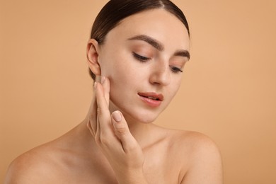 Photo of Beautiful young woman with healthy skin on beige background