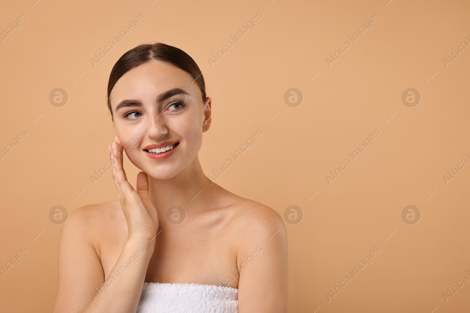 Photo of Beautiful young woman with healthy skin on beige background, space for text