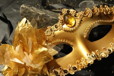 Beautiful golden carnival mask on table, closeup