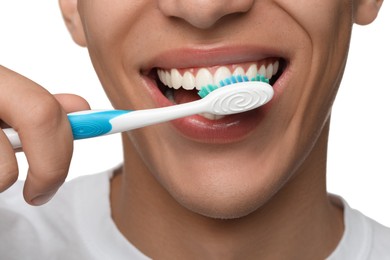 Photo of Young man brushing his teeth on white background, closeup